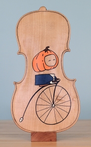 "The Headless Highwheeler", acrylic and marker on reclaimed maple violin back.
